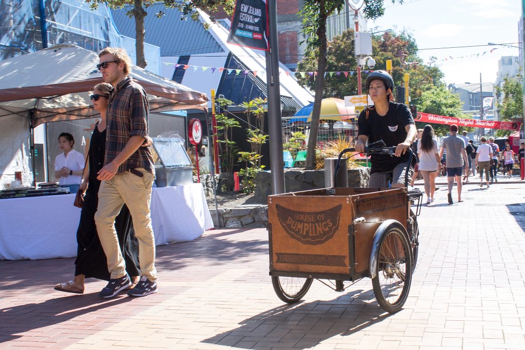 Man on bike delivering food in Cuba Street