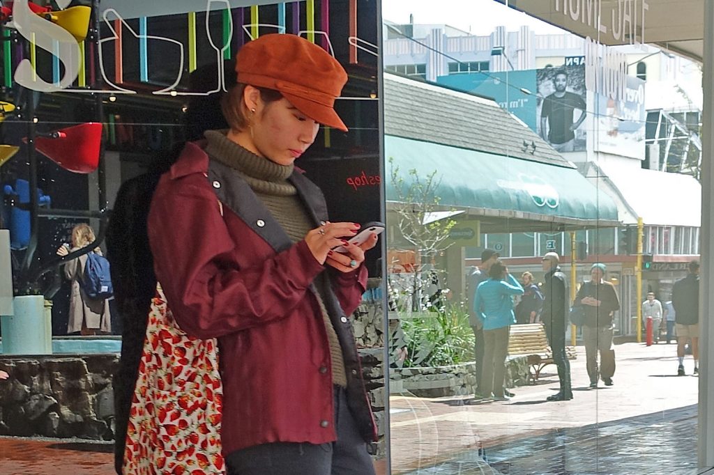 Woman texting In Cuba Street