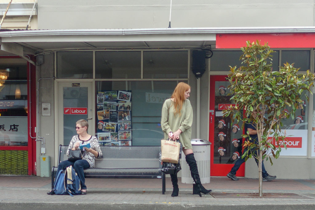 Woman at bus stop in Petone