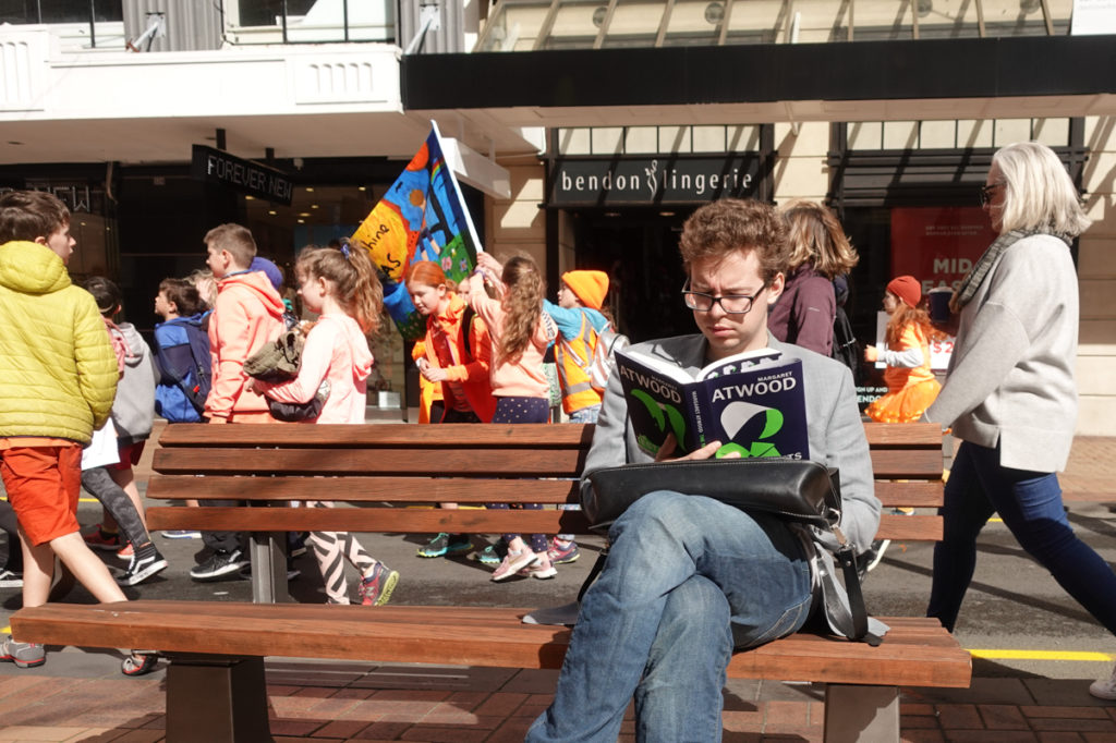 Man reading book in Lambton Quay